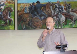 Ron Levenson speaks about his late father, Sol, who painted the three Civil War murals that now reside in the St. Albans Historical Museum. One of those is visible behind him.