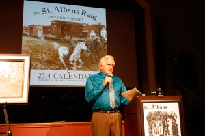 Richard Cummings unveils the St. Albans Raid Commemorative Calendar on Thursday evening, Oct. 3, in the Bliss Room at the St. Albans Historical Museum. The calendar used artwork submitted by local and Vermont artists to depict the historic St. Albans Raid, which the community will celebrate its 150th anniversary next year. Photo By IAN LORD, St. Albans Messenger